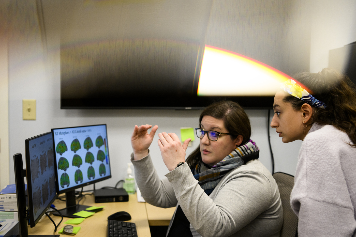 Erin Meier explaining images on a computer screen to leanna ugent