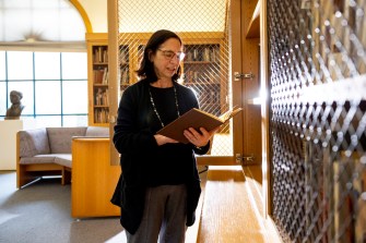 Librarian Janice Braun looks through the Special Collections within the Heller Rare Book Room at the Mills College Library.