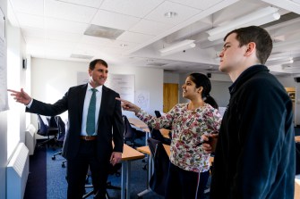 Professor showing students something on a white board