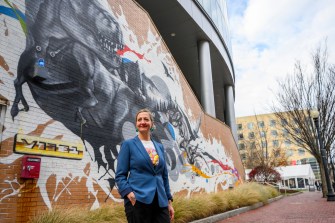 rebekah moore posing in front of a mural