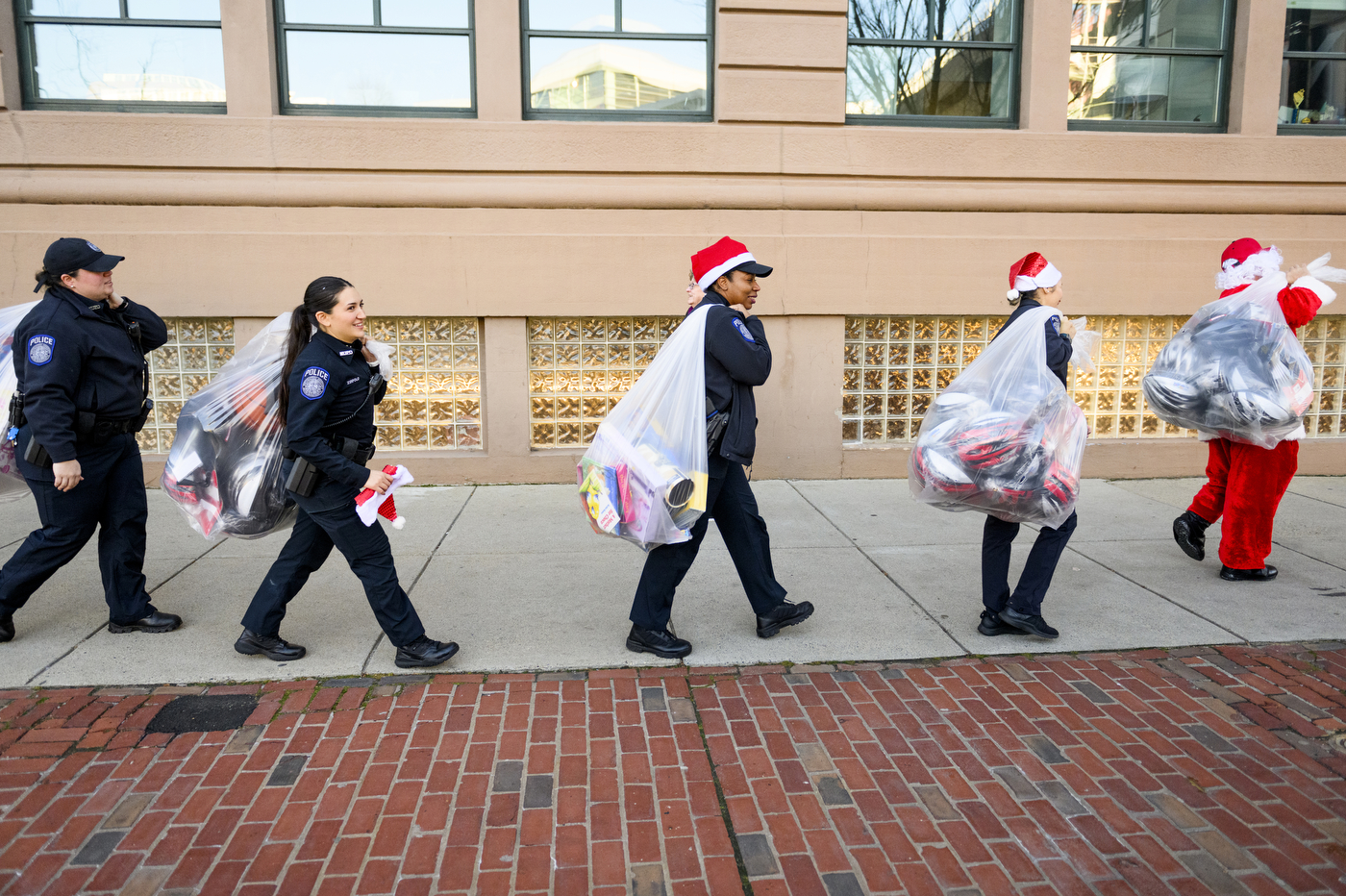 police officer carrying bags of toys 