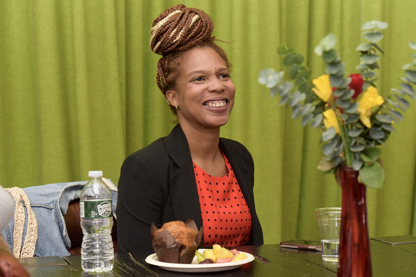 person sitting at a table smiling