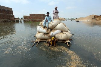 flood victims on makeshift barge