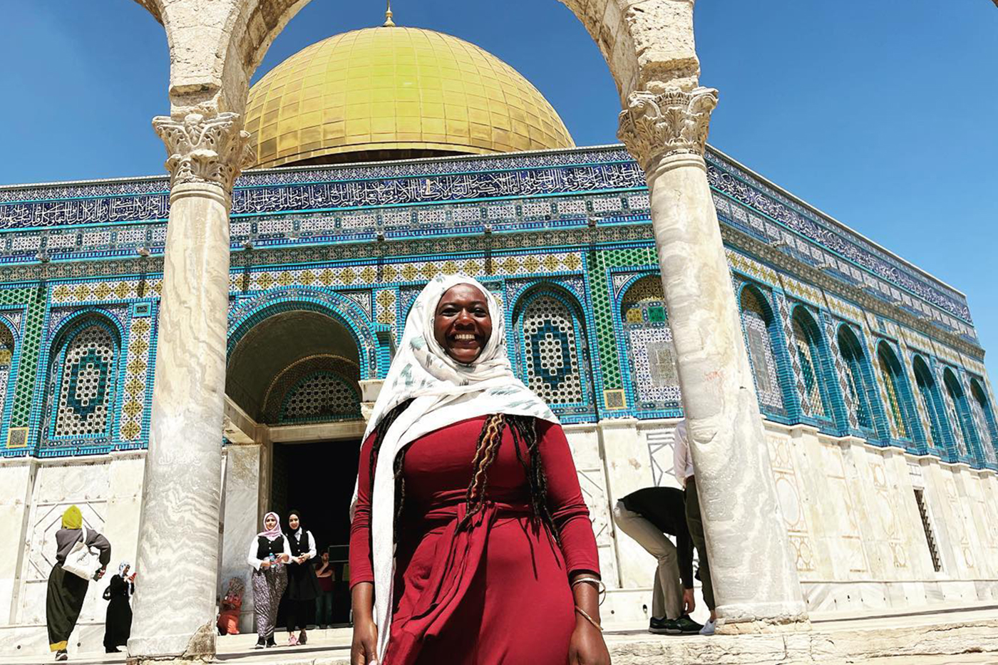 person standing outside of a mosque