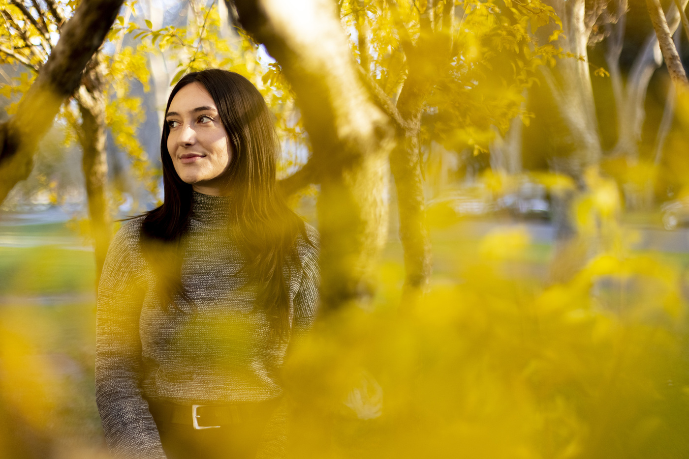 Trinity Thomas framed by yellow leaves