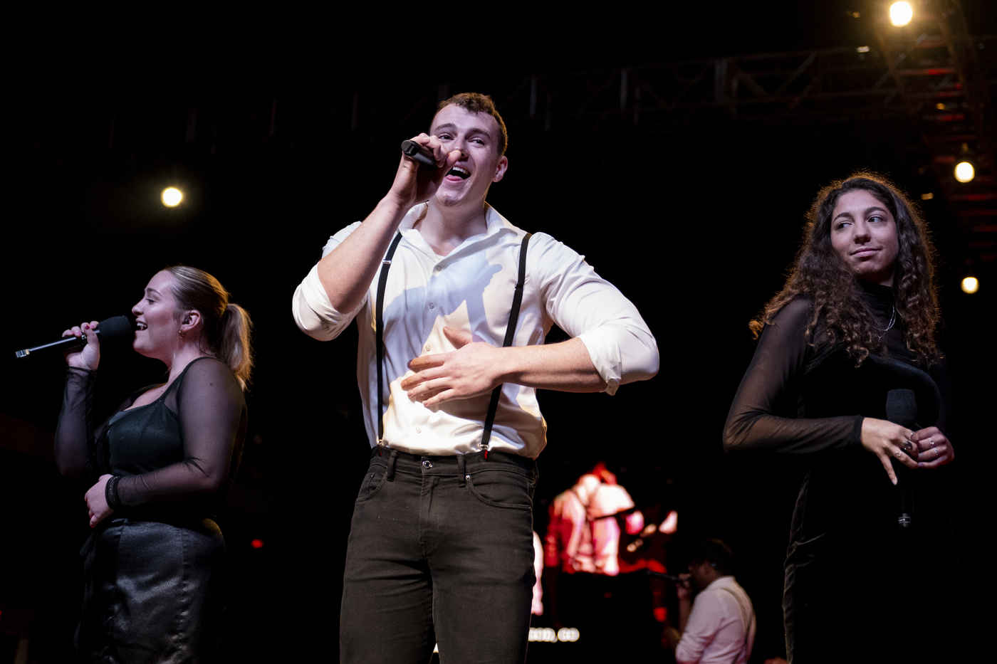 Members of the Nor'easters sing on stage. 