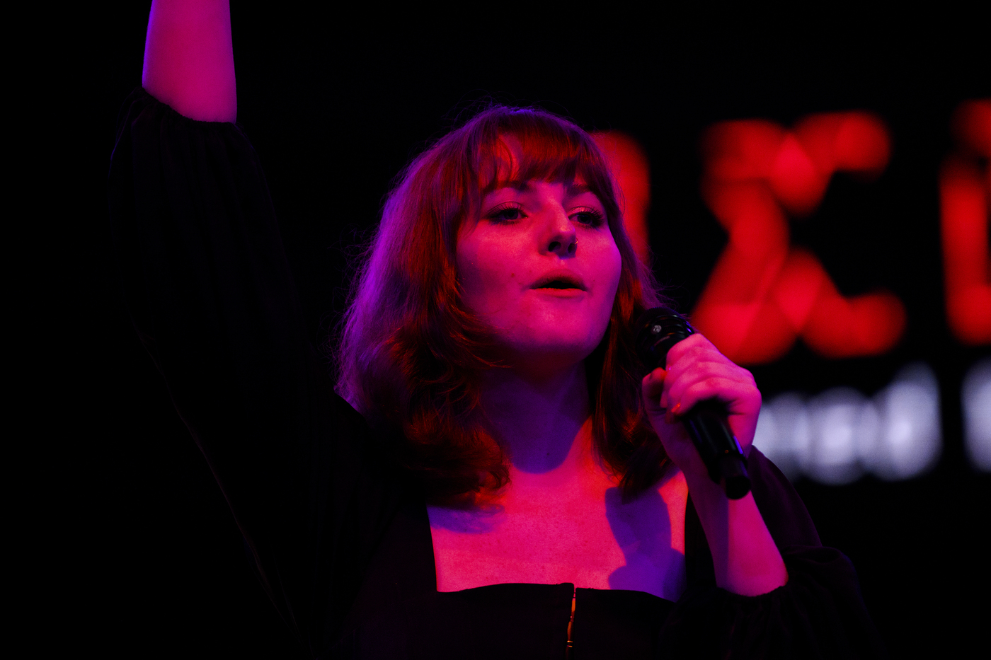 A member of the Nor'easters sings on stage. 