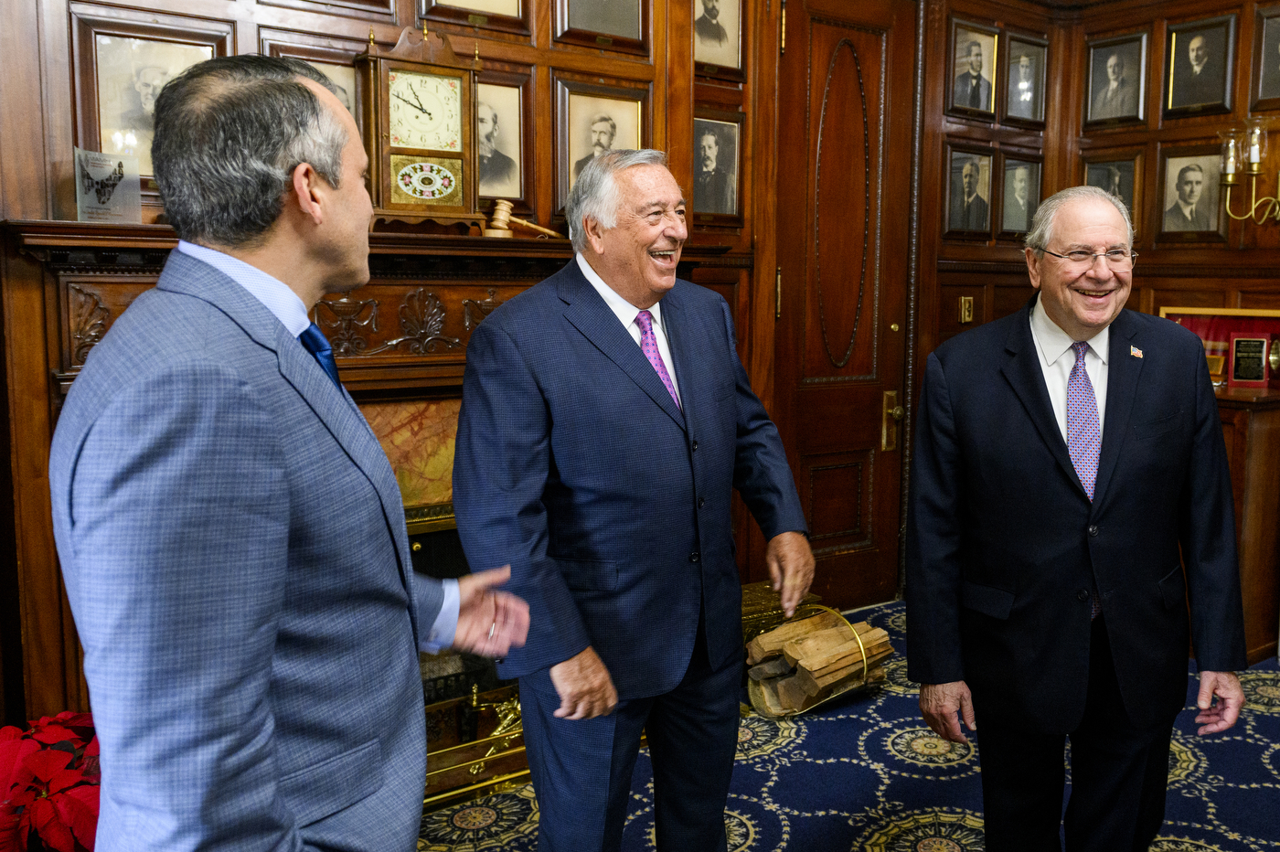 robert deleo stands with two other men in the massachusetts state house chamber