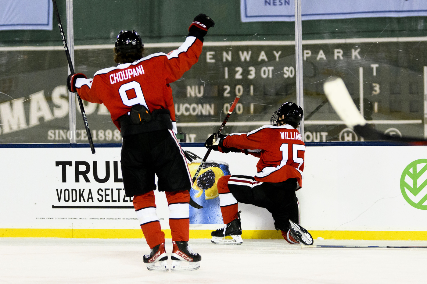 Northeastern hockey players cheering with excitement. 