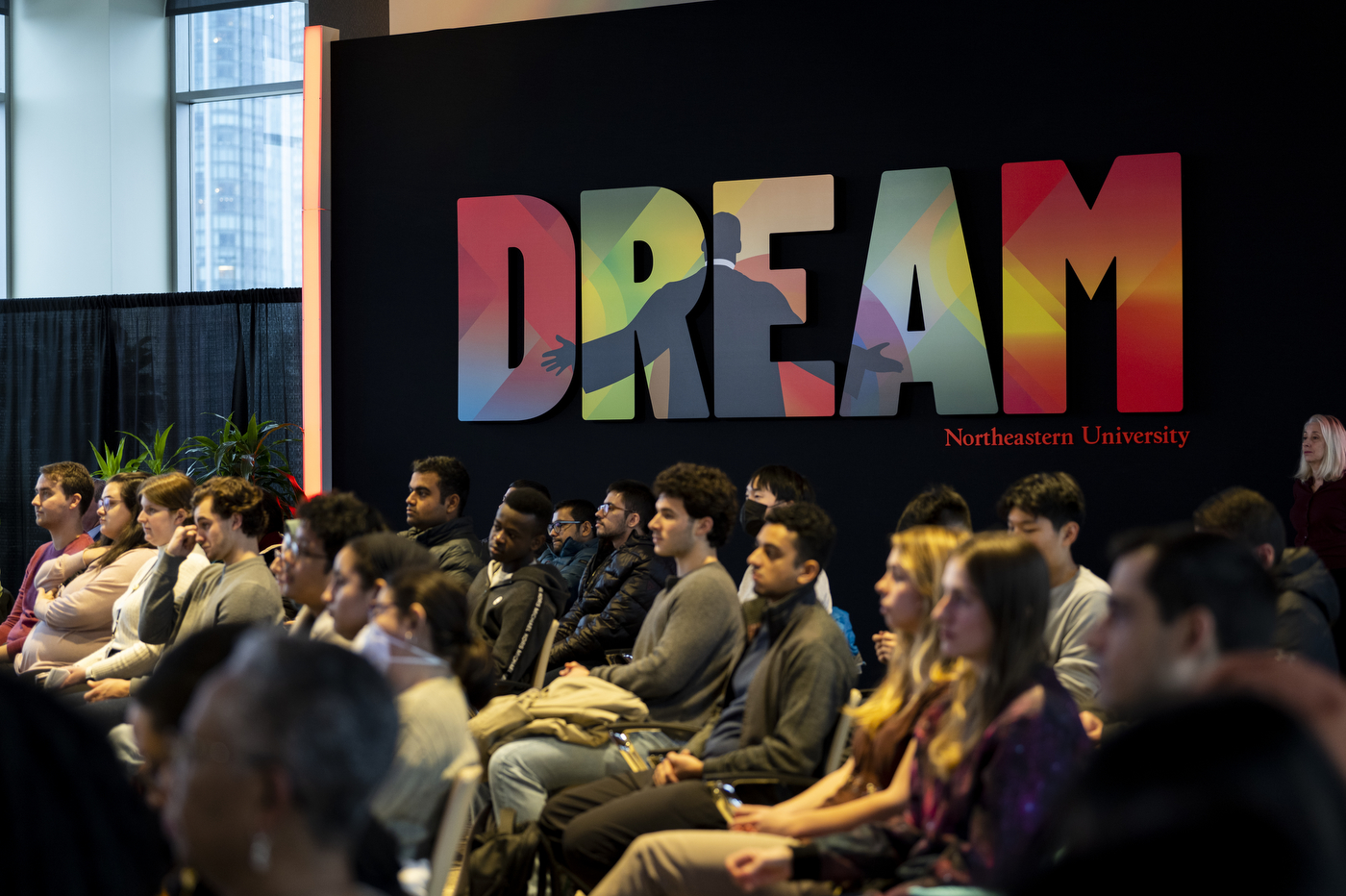 A group of people sits in the audience of Northeastern's celebration of Martin Luther King Jr.