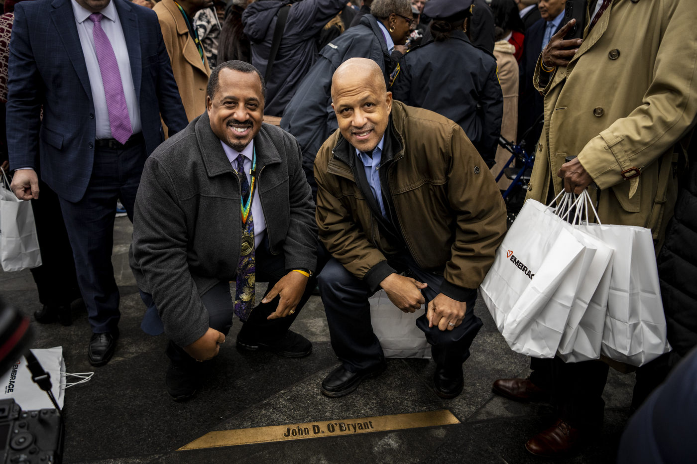 Richard and James O'Bryant kneel behind the name John D. O'Bryant 