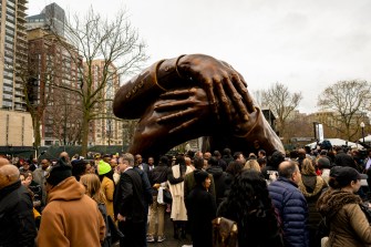 The Embrace statue surrounded by onlookers