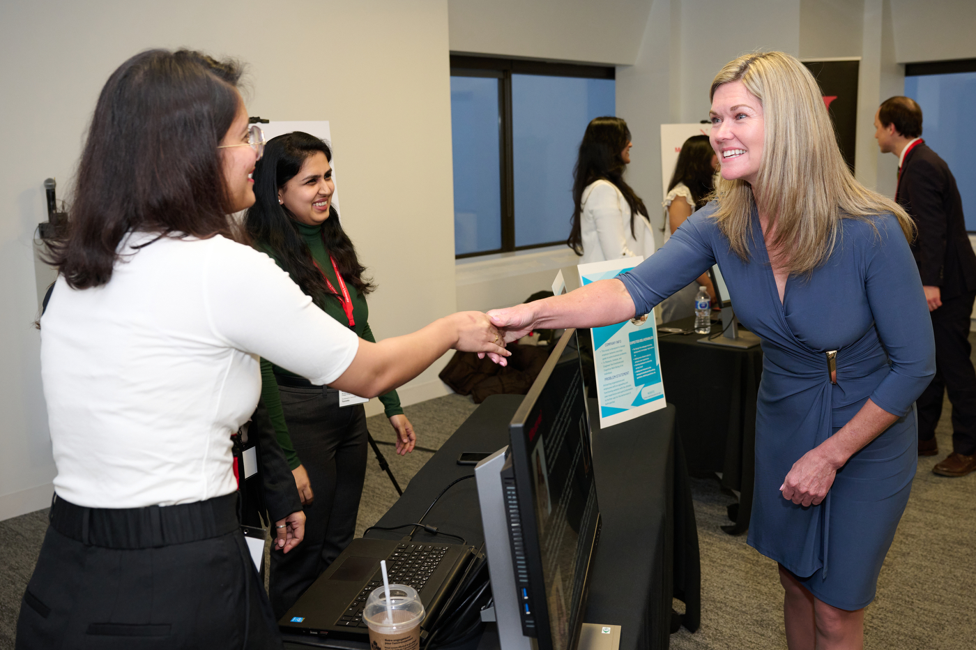 jill dunlop shaking hands with a student