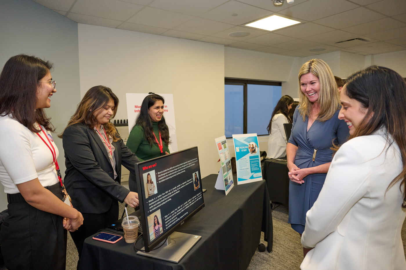 jill dunlop reading a student's poster board