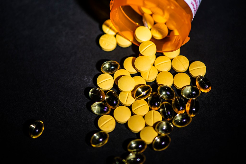 Pills spilling out of prescription container