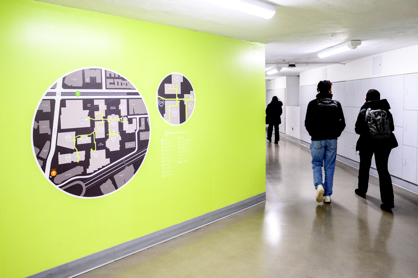 students walking in underground tunnel