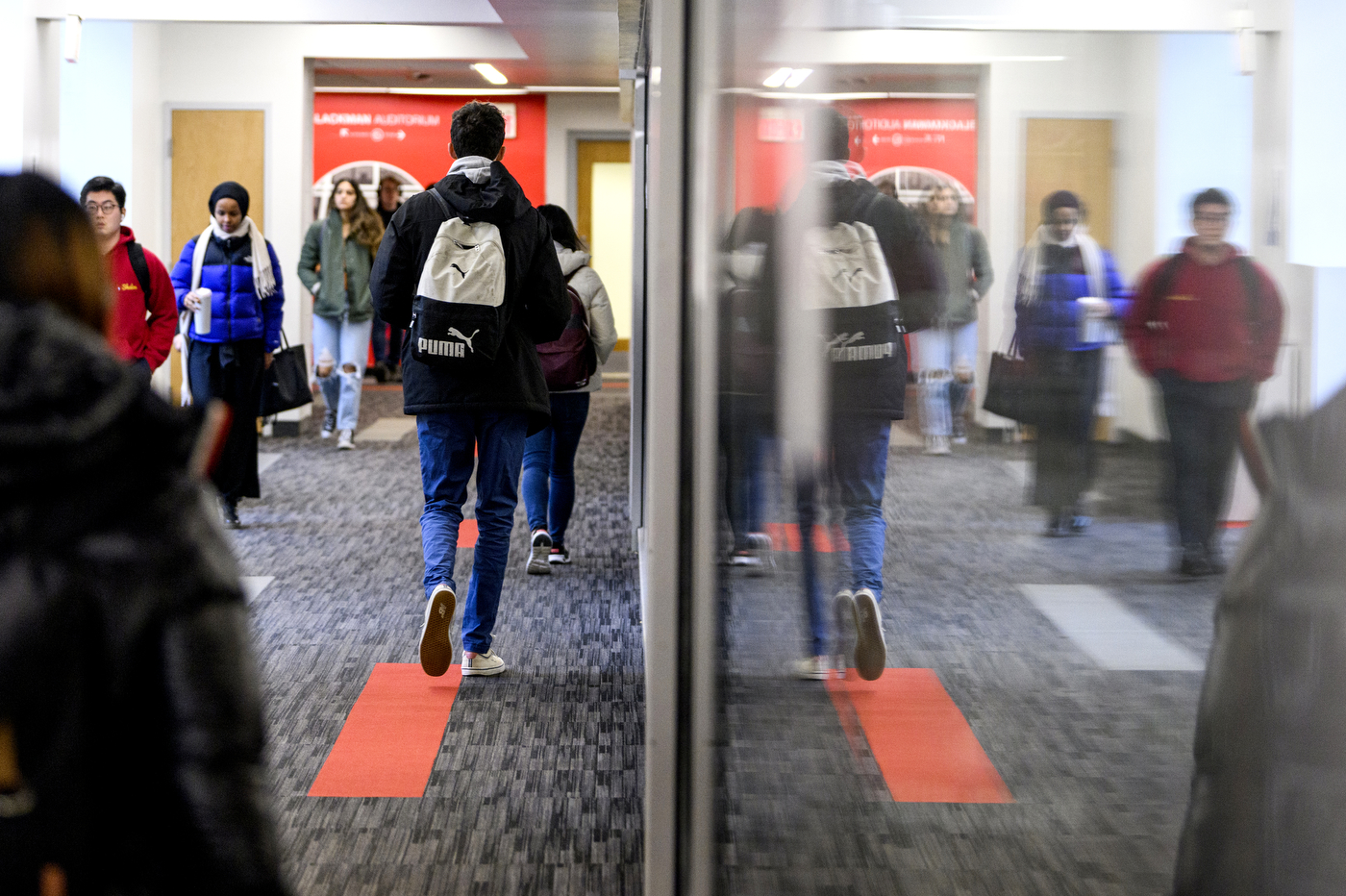 students walking in underground tunnel