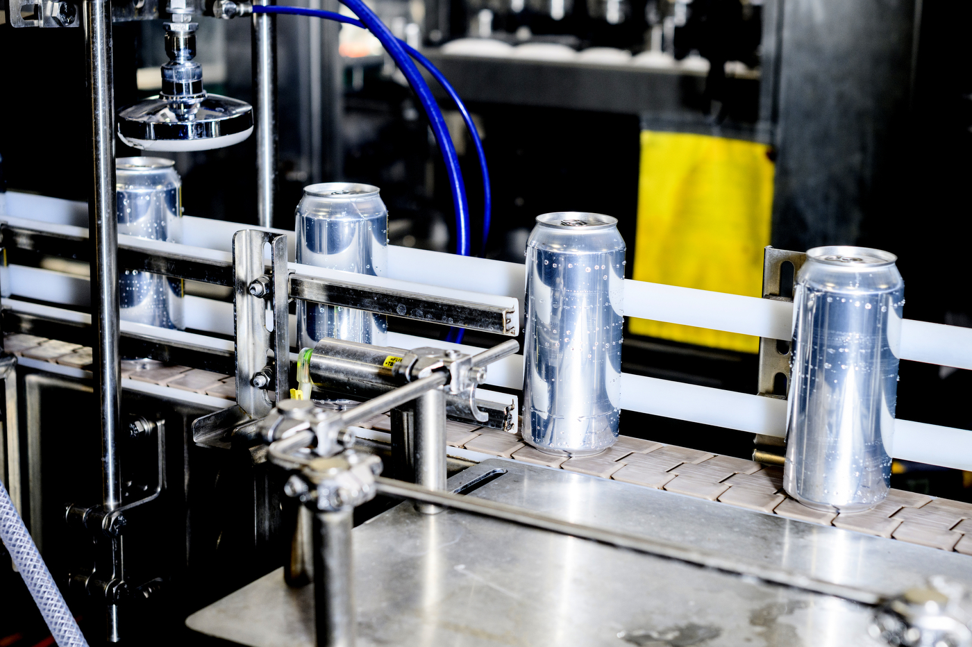 Rupee Beer cans on machine for labeling