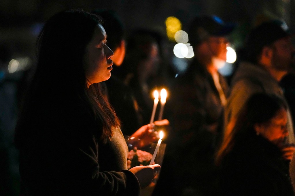 person holding candle at vigil