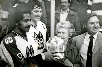 Wayne Turner and dave Archambault holding Beanpot trophy