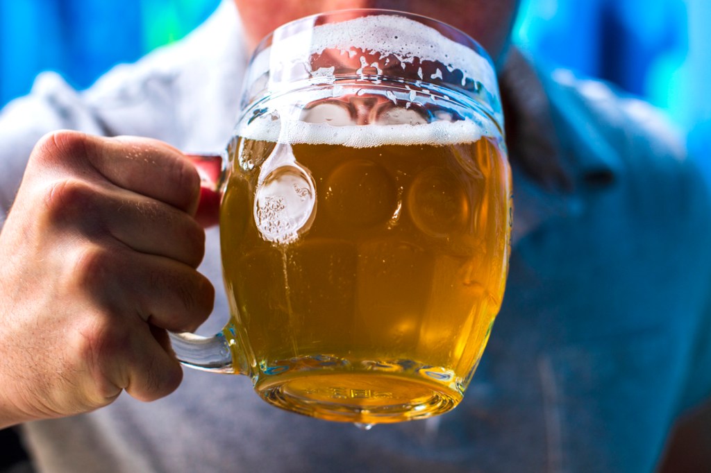 person holding mug of beer