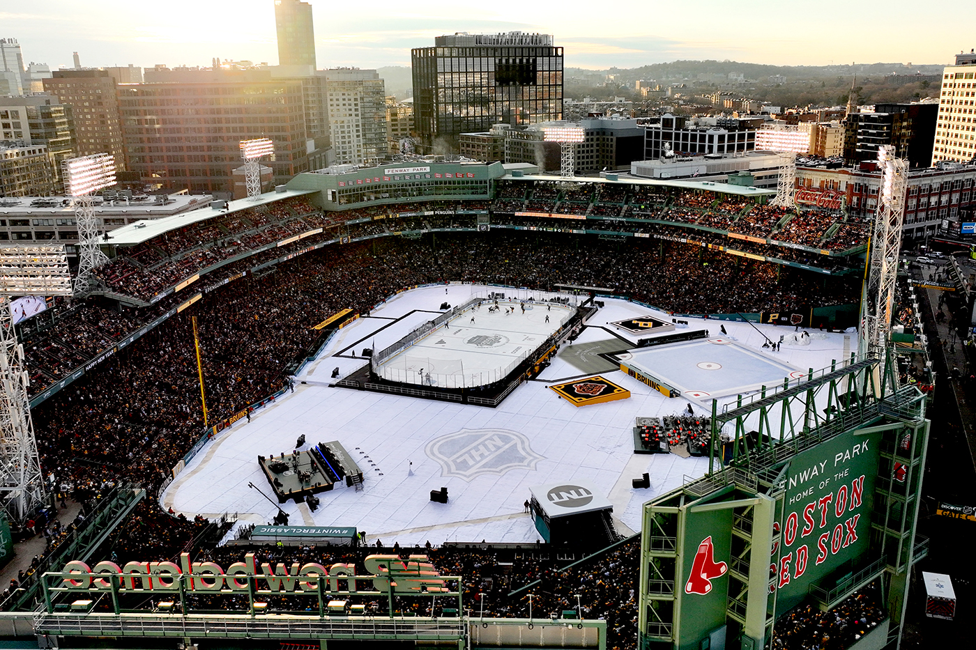 An aerial view of Fenway Park, frozen over and with various ice rinks on the field