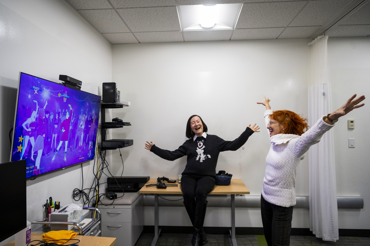 Two professors playing active video game