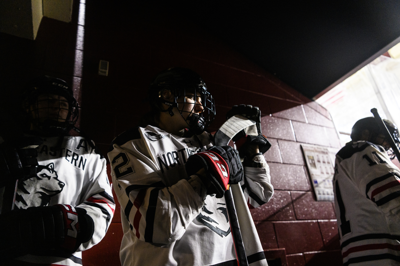 northeastern womens hockey players lined up waiting to enter rink