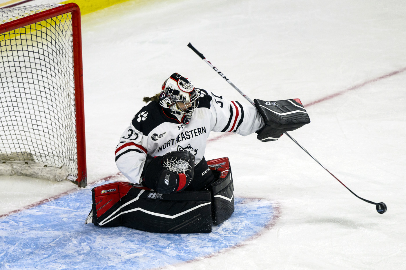 northeastern womens hockey goalkeeper saves a shot on net