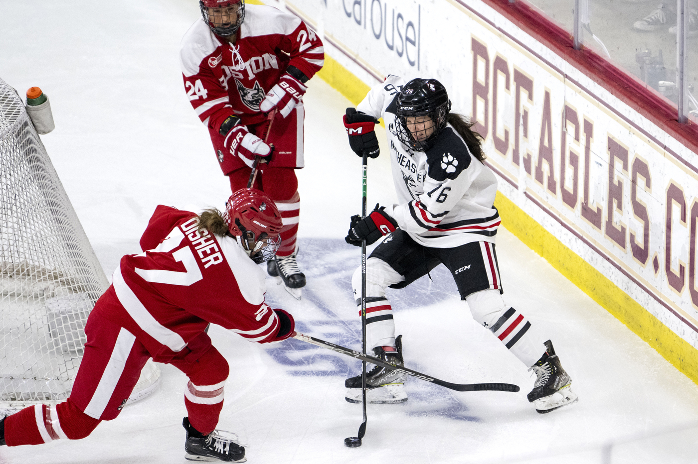 northeastern womens hockey player taking a shot