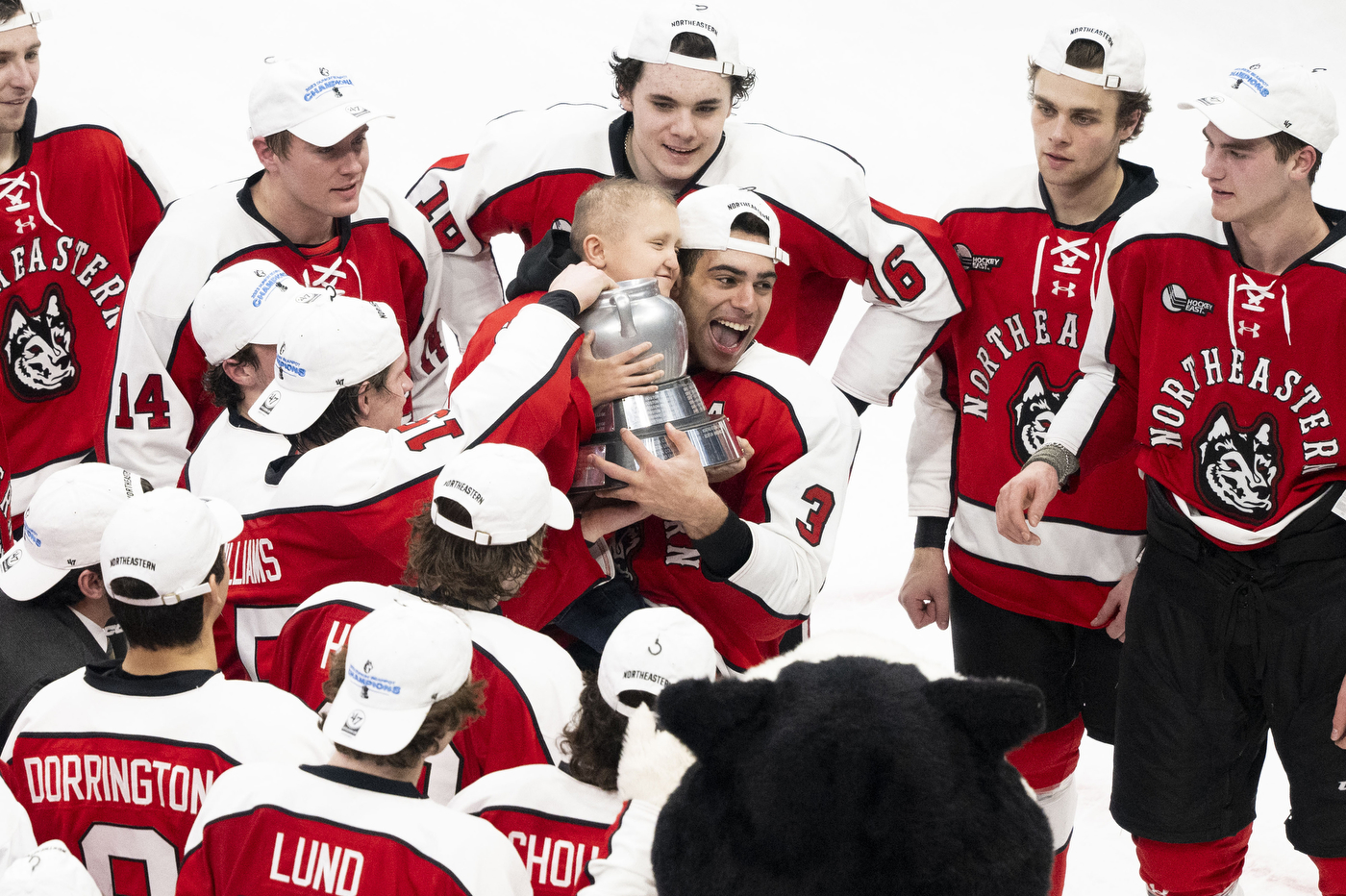 northeastern mens hockey team celebrating the beanpot win on the rink