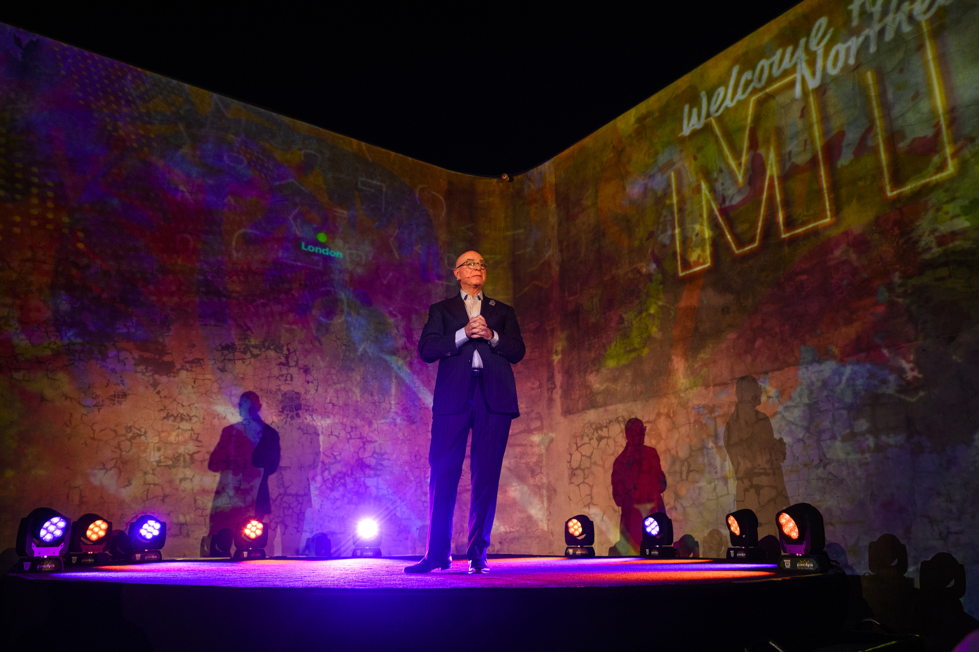 Northeastern University President Joseph E. Aoun stands on a stage