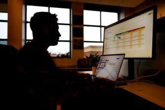 A person works at a computer in an office