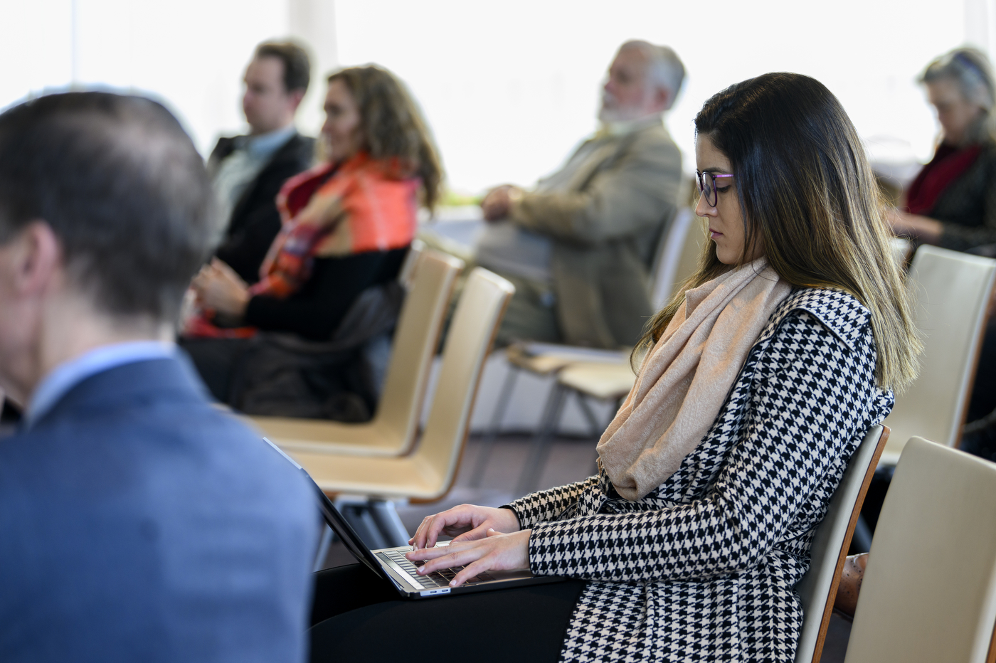 person typing notes on a laptop at the fireside chat