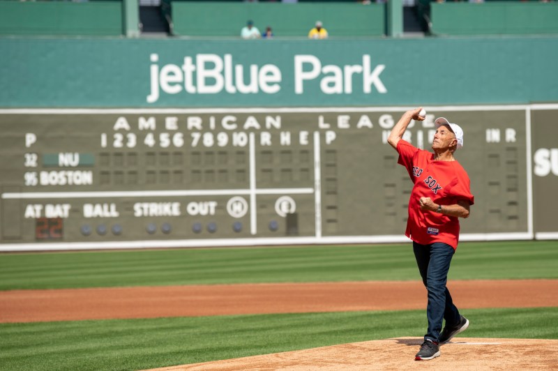 A person stands on the mound throwing a ball