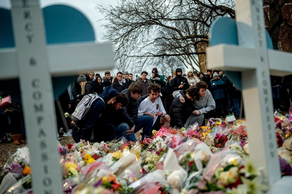 Two white crosses stand over a memorial to students killed at Michigan State University