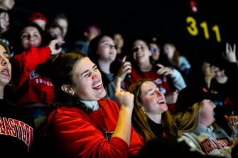 northeastern fans singing and dancing in fan section