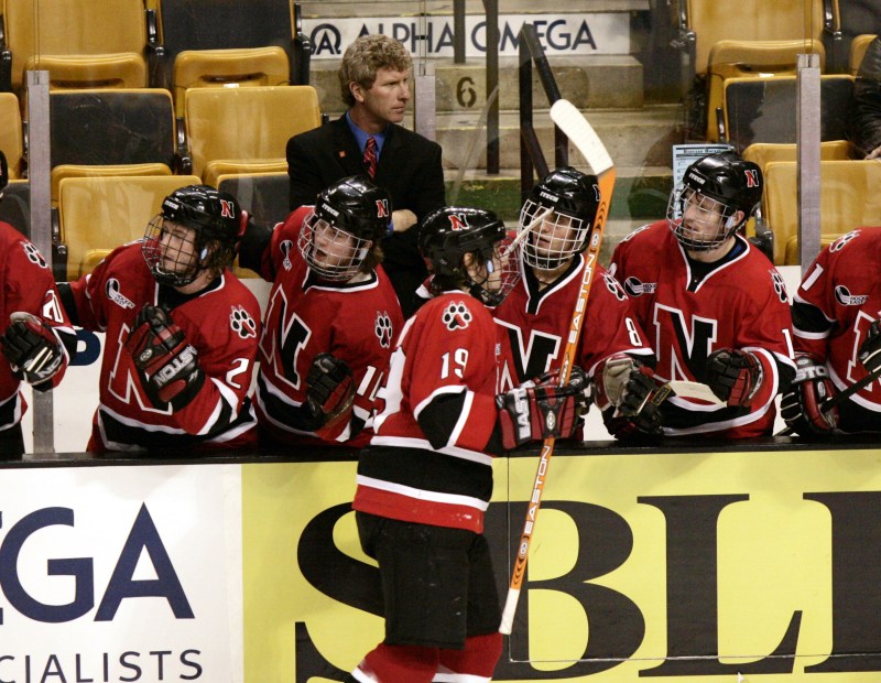 northeastern hockey player fist bumping his teammates