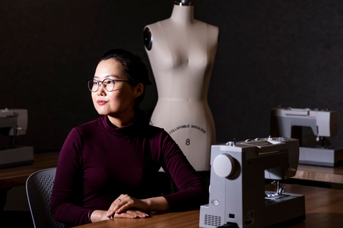 Bolor Amgalan posing next to a sewing machine