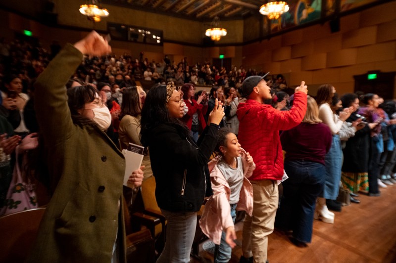 audience members cheering and clapping for angela davis