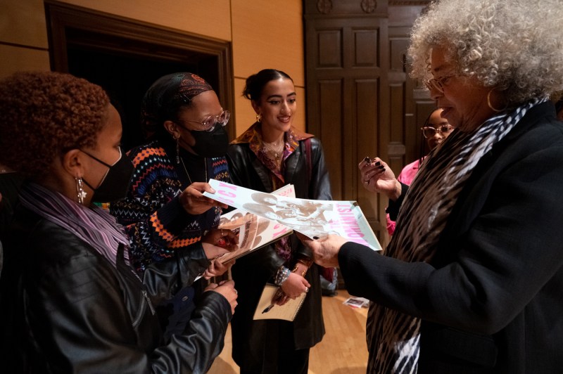 angela davis signing a poster