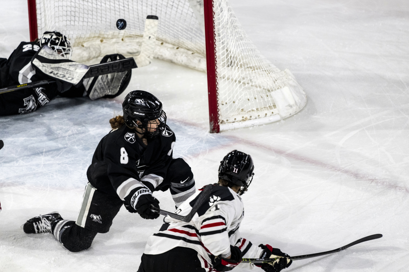 A player watches her shot go into the goal