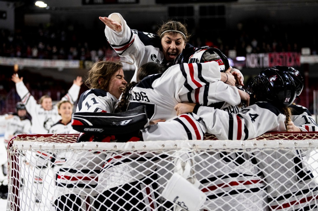 Players gather around their goal in celebration