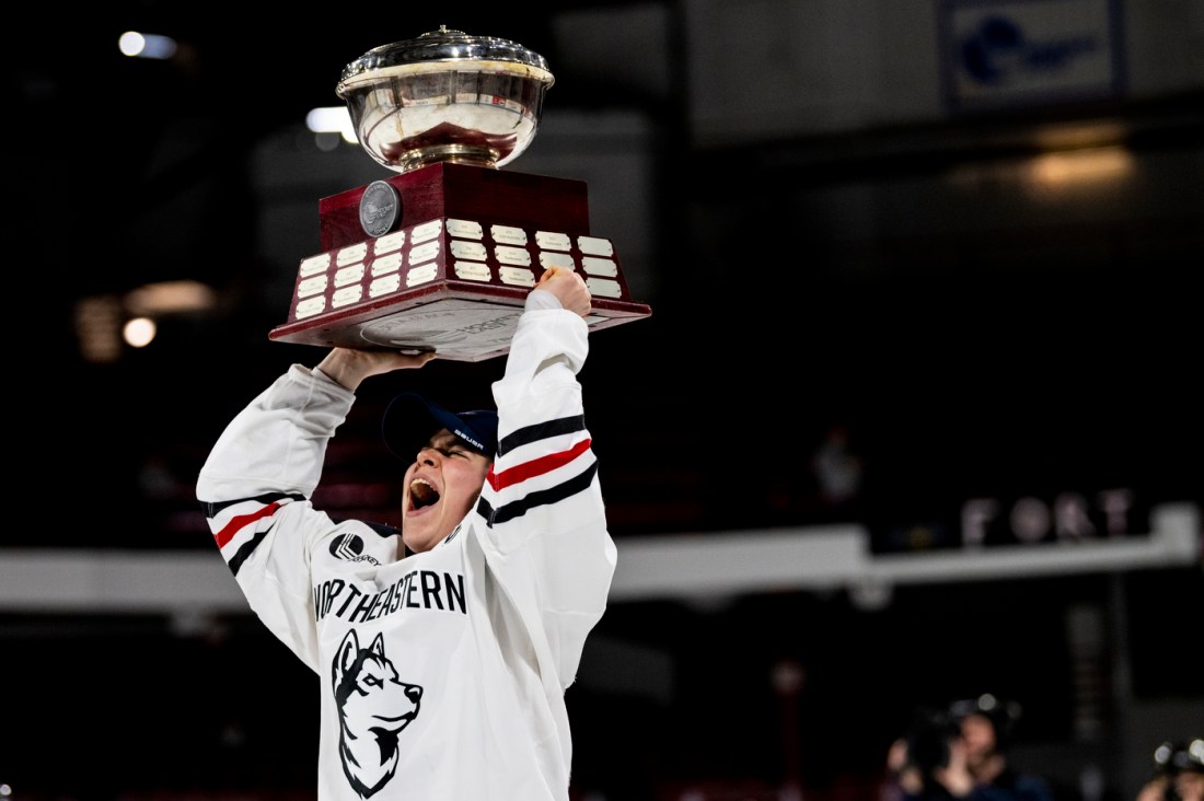 A player screams while raising a trophy