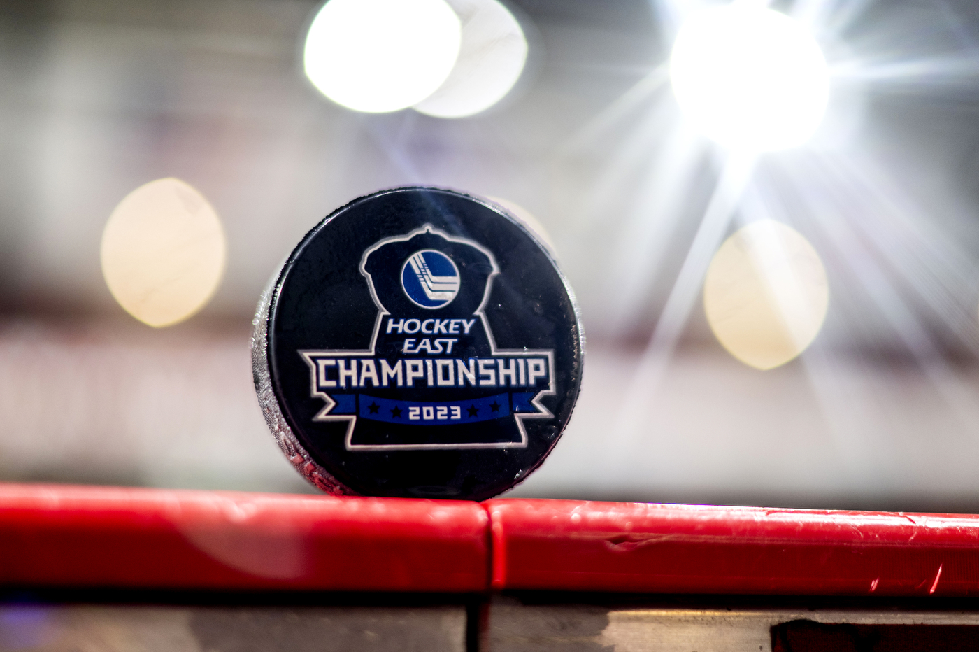 A puck is balanced on a railing