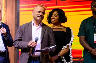 Subodh Chanrai presenting a scholarship on stage at the Global Leadership Summit in Ghana