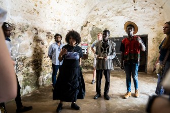 Vanessa Johnson speaking to a group of people in Elmina Castle