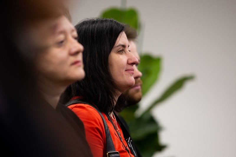 three audience members at moderated discussion about AI at Northeastern's Devon House