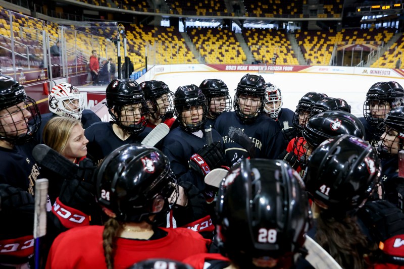 hockey players huddling before NCAA game