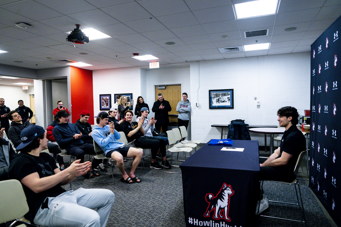 Devon Levi's teammates and friends clap for him at his signing